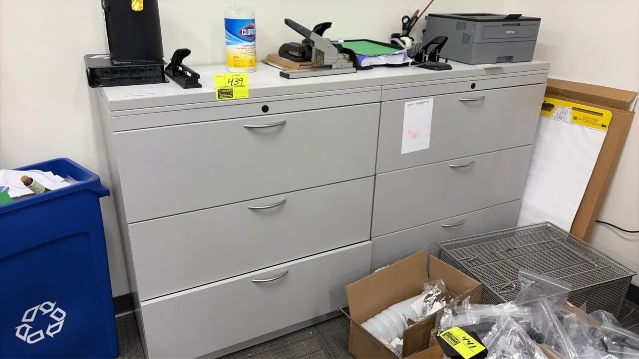 Office suite package lot including (2) metal 3-drawer lateral file cabinets, Brother printer, and assorted office supplies. Cabinets feature a light g