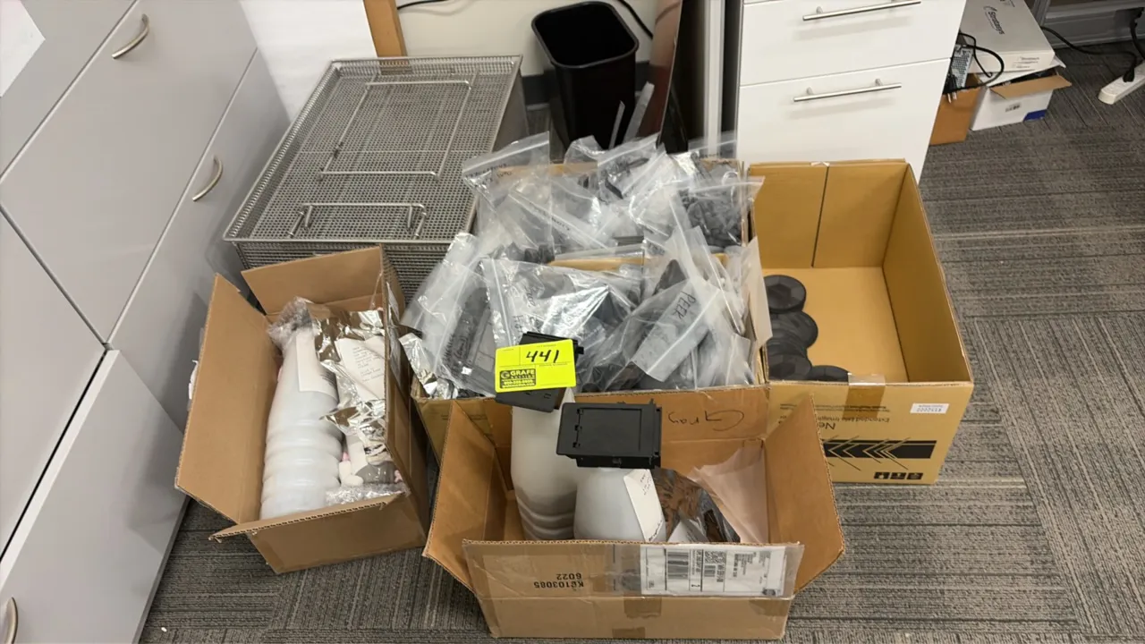 Assorted parts, components, and stainless steel wire mesh basket. Includes bagged plastic components, canisters with caps, circular parts, and a stain