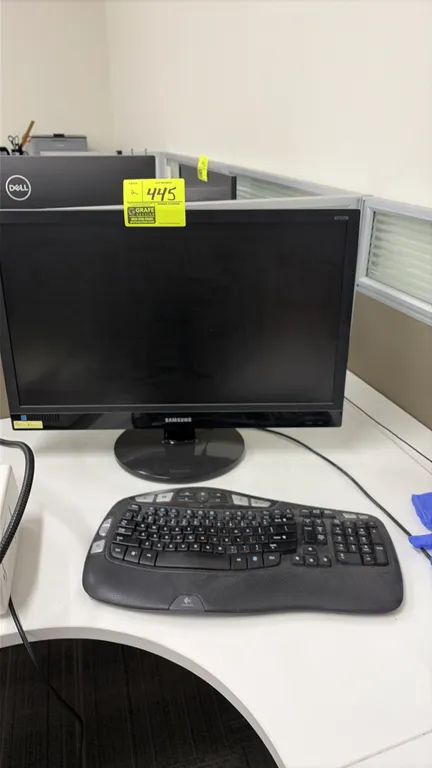 Samsung 24" computer monitors. Features widescreen display and black finish. Mounted on desktop stands. Keyboard and desk accessories not included.