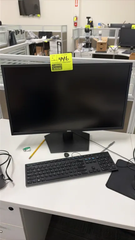 Dell 24" monitors. Features widescreen display and black desktop stands. Note: Keyboard, computer peripherals, and desk contents not included.