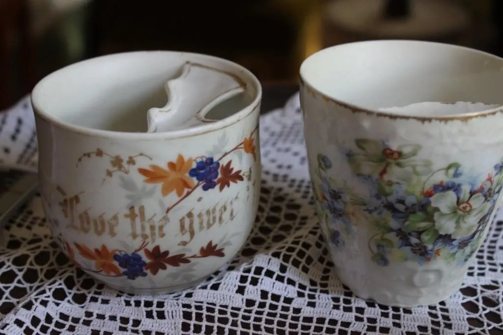 Pair of antique hand-painted porcelain mugs