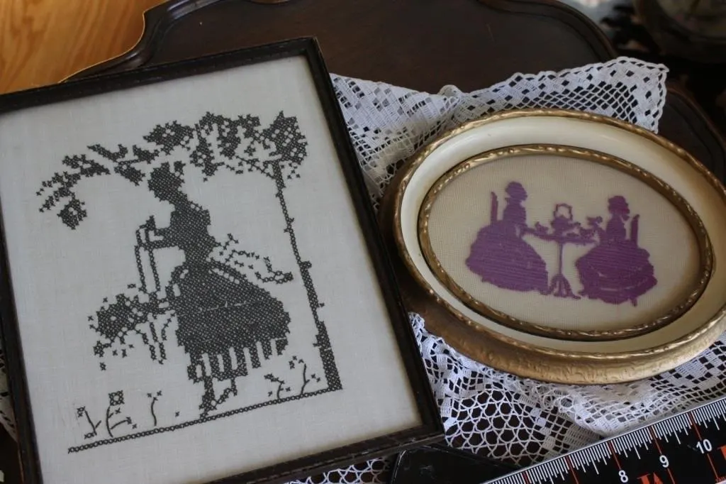 Pair of framed cross-stitch silhouette