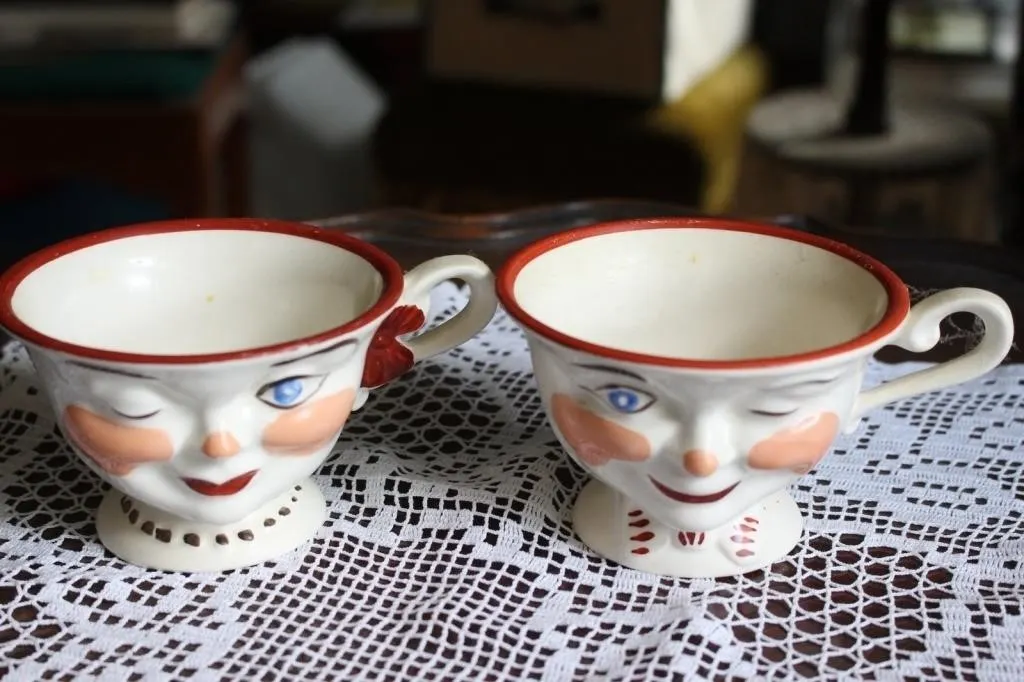 Pair of Winking Face Teacups, Staffordshire