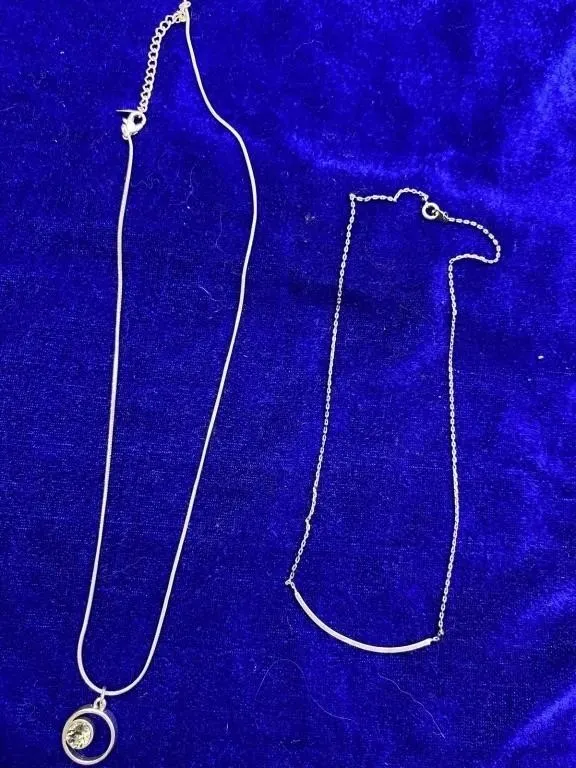 Two silver-tone necklaces with pendant