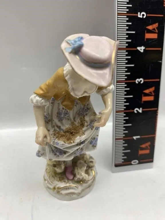 Porcelain figurine of lady in bonnet feeding birds