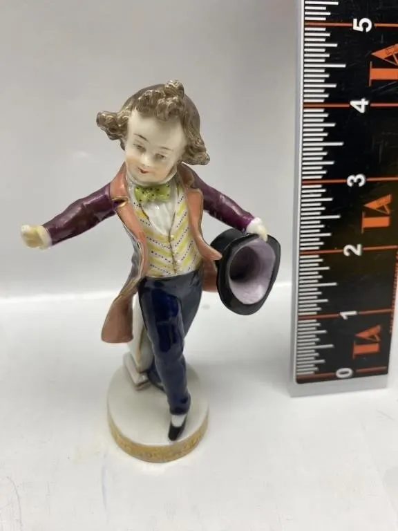 Porcelain Figurine of Boy in Coat Holding Top Hat