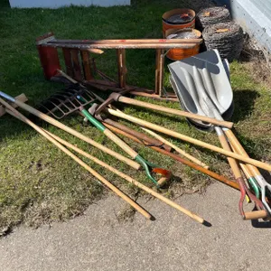 Variety of Hand Tools and Wooden Ladder