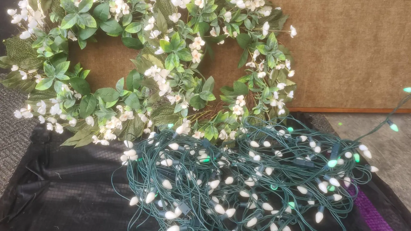 2 Floral Wreaths with White Flowers and String of White Outdoor Lights