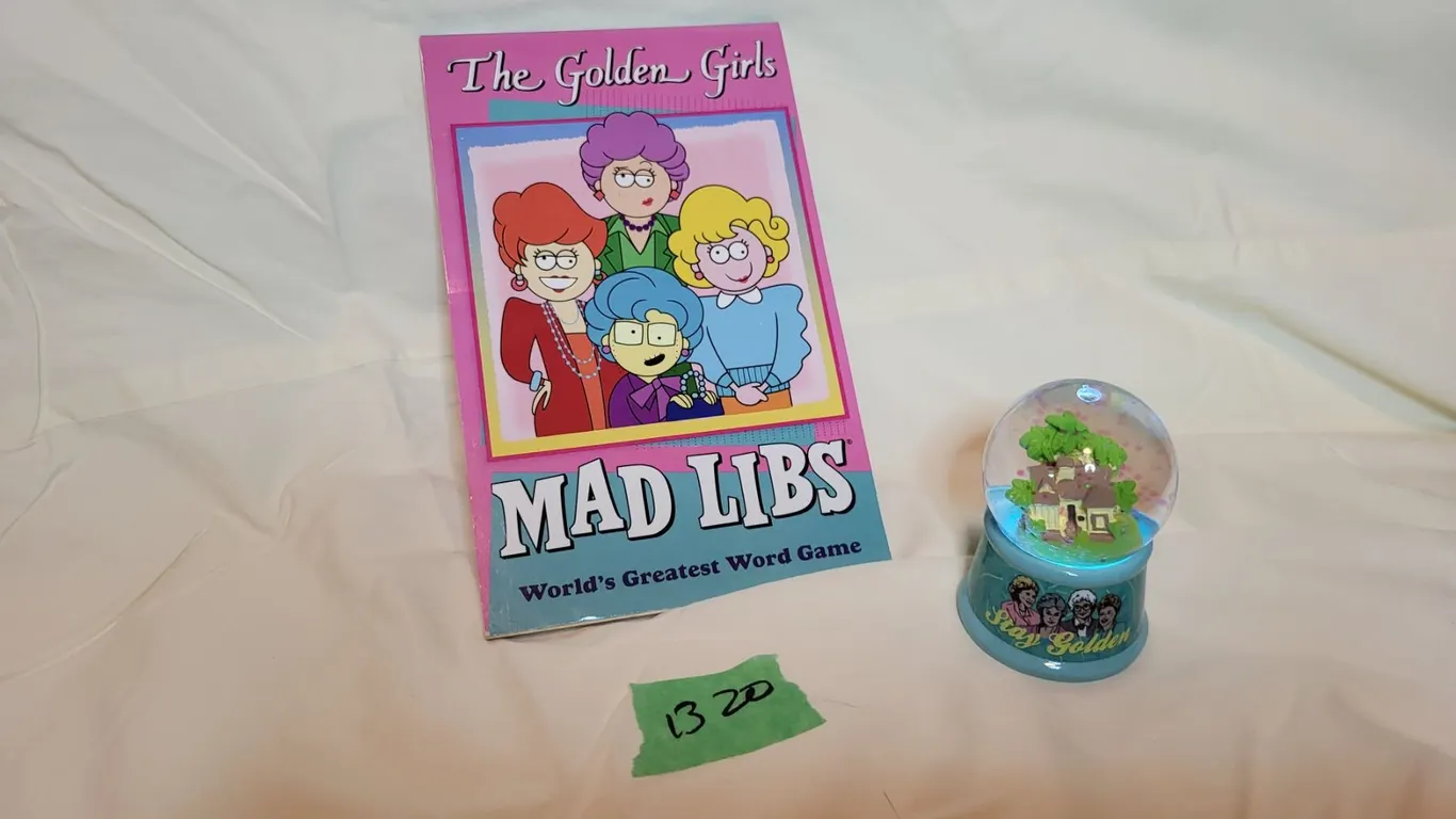 THE GOLDEN GIRLS MadLib game book, and battery-operated, multi-coloured glitter globe of THE GOLDEN