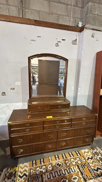 VINTAGE WOODEN 9-DRAWER DRESSER WITH ATTACHED MIRROR AND BRASS-TONE HARDWARE