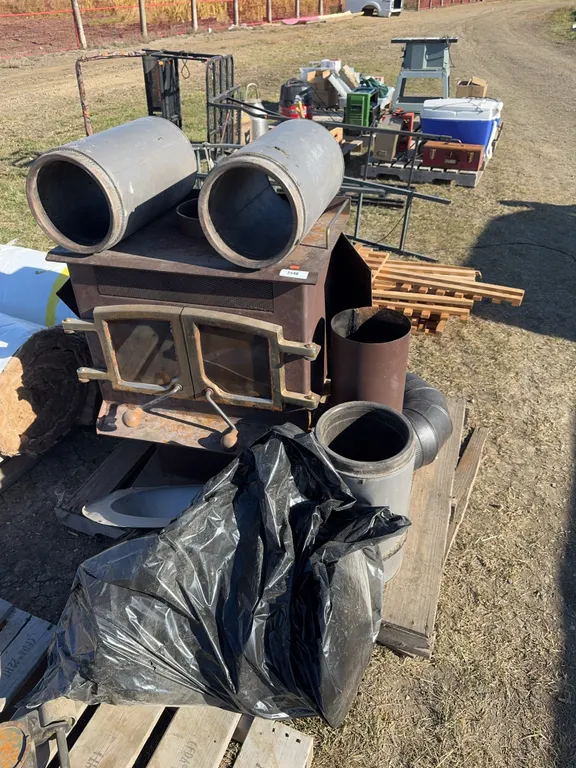 Wood stove c/w some chimney and stove pipe pieces