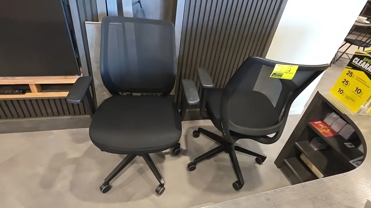 Mesh-back adjustable office chairs. Features black mesh backrests, black fabric cushioned seats, adjustable armrests, and pneumatic height adjustment.