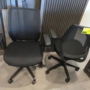 Mesh-back adjustable office chairs. Features black mesh backrests, black fabric cushioned seats, adjustable armrests, and pneumatic height adjustment.