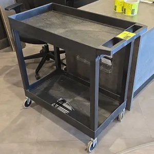 Poly 2-tier utility cart. Features molded plastic construction with two tub shelves and an integrated push handle with storage wells. 3'L. Mounted on 