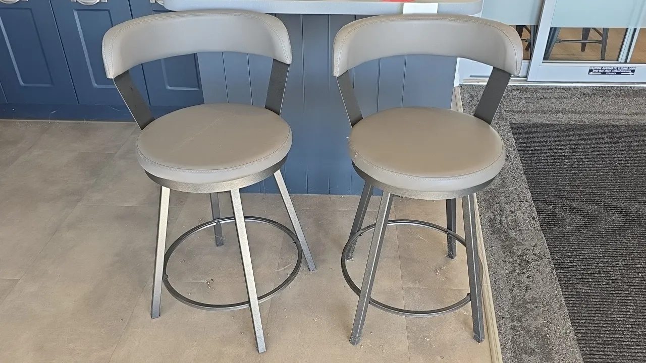 2022 Hong Van swivel stools. Features gray faux leather upholstered padded seats and curved backrests, swivel mechanism, and metal frames with integra