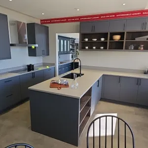 Infinity Plus kitchen cabinet set. Includes 105"L upper and lower cabinets with solid surface countertops, 104" x 99" L-shaped cabinet run with underm