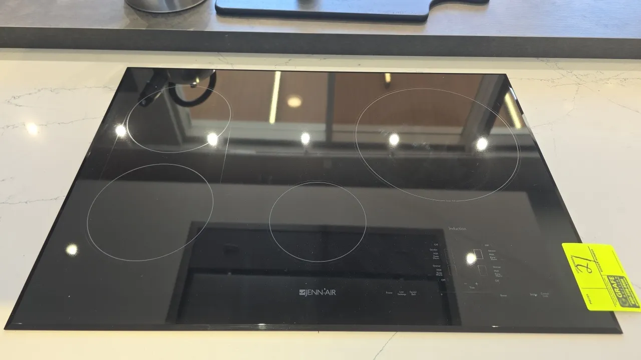 JennAir JIC4430XB 4-burner induction cooktop. Features black ceramic glass surface, digital touch controls, bridge function, sensor boil, and control