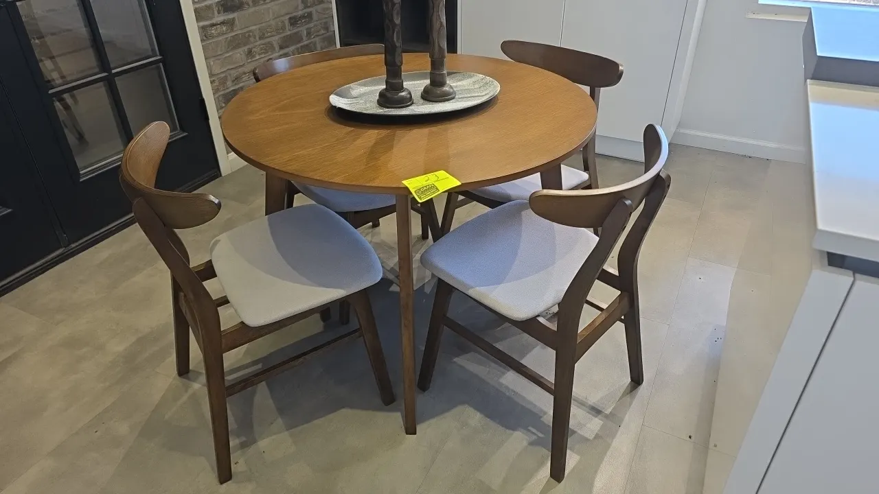 Laminate wood dining table set. Includes round dining table and (4) matching chairs with cushioned fabric seats and wood frames. Dimensions: 40" x 30"