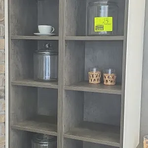 Assorted smallwares and decorative accents. Includes (3) lidded glass storage jars, stainless steel tea kettle, wooden serving board, metal ring sculp