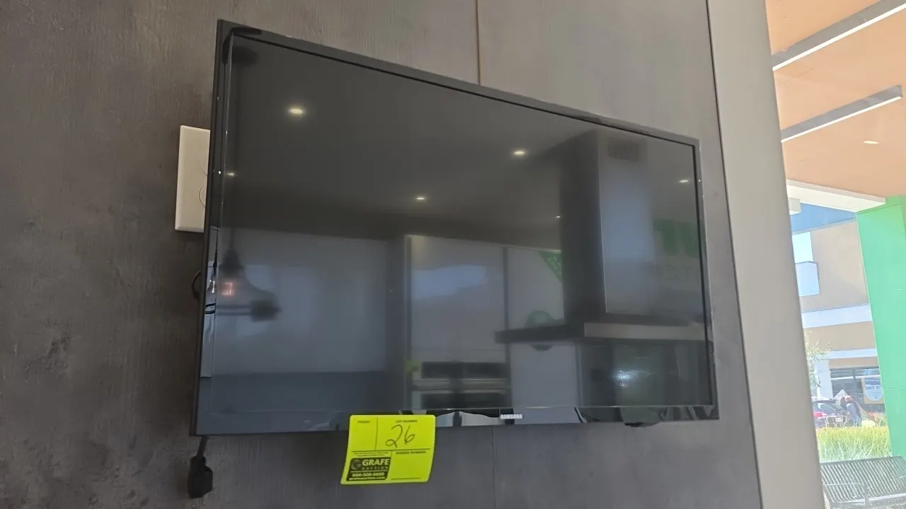 Samsung 32" flat screen TV. Features a black bezel and included Peerless-AV wall mount bracket with power supply adapter.