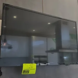 Samsung 32" flat screen TV. Features a black bezel and included Peerless-AV wall mount bracket with power supply adapter.