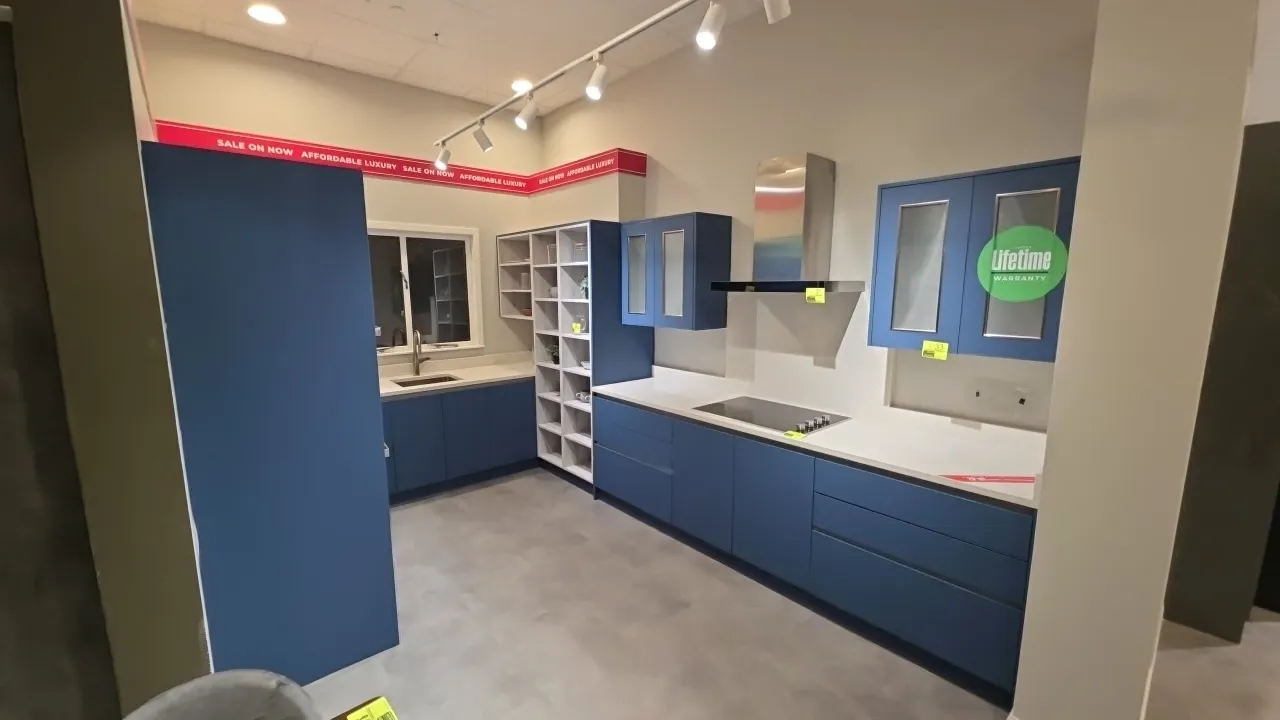 Infinity Plus U-shape upper and lower kitchen cabinets. Features solid surface countertops, backsplash, stainless steel sink with faucet, open shelvin