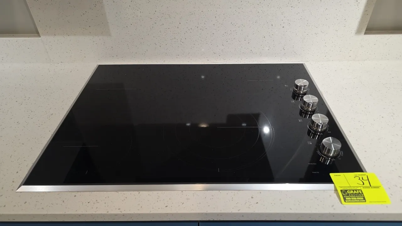 JennAir JEC3430HS00 30" electric cooktop. Features black ceramic glass surface with stainless steel trim, 4 radiant heating elements, and side-mounted