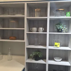 Assorted kitchen smallwares and decor items. Includes glass storage jars with wood lids, glass measuring pitchers, ceramic mugs, ceramic bowl, plates,