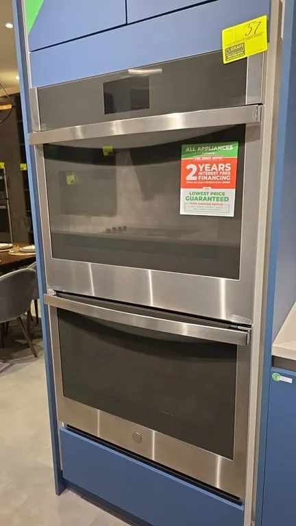 GE Profile PTD7000SN3SS built-in double wall oven. Features stainless steel exterior with glass front doors, touchscreen display with Wi-Fi Connect, a
