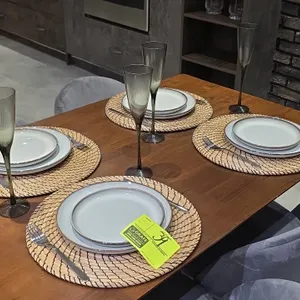4-place setting dining smallwares set. Includes (4) round woven placemats, (8) ceramic plates, (4) smoked glass flutes, and stainless flatware (forks 