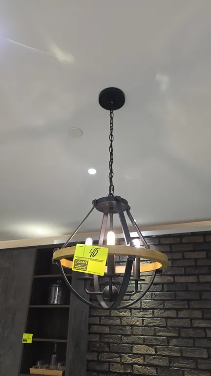 Metal and wood pendant light fixture. Features open cage design with natural wood accent band, 4-light candelabra cluster, hanging chain, and ceiling