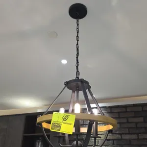 Metal and wood pendant light fixture. Features open cage design with natural wood accent band, 4-light candelabra cluster, hanging chain, and ceiling 