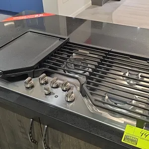 GE Profile PGP9036SL2SS 5-burner natural gas cooktop. Features stainless steel finish, continuous cast iron grates, and control lock. Includes 12" x 1