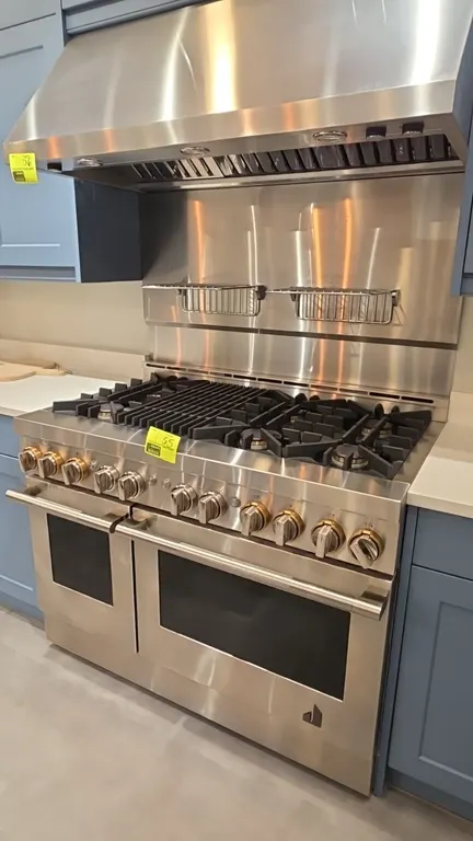 JennAir JGRP648HL01 48" natural gas range. Features stainless steel construction, 6 gas burners with center grill, double oven, and backsplash with (2
