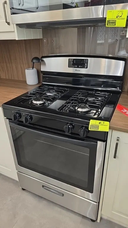 Amana AGR5330BAS3 4-burner natural gas range. Features stainless steel exterior, 4 gas burners, digital display controls, oven with window and wire ra