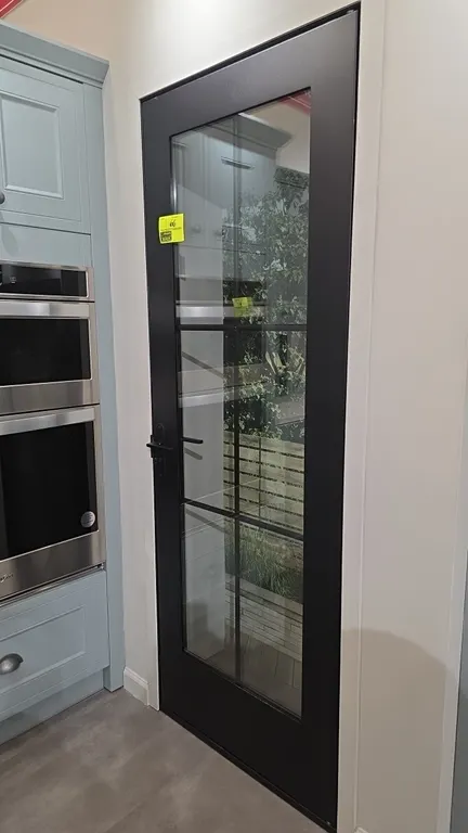 Metal 6-glass panel door. Features a dark gray finish and matching lever handle and deadbolt. 29"W x 80"H. Note: Background items not included.