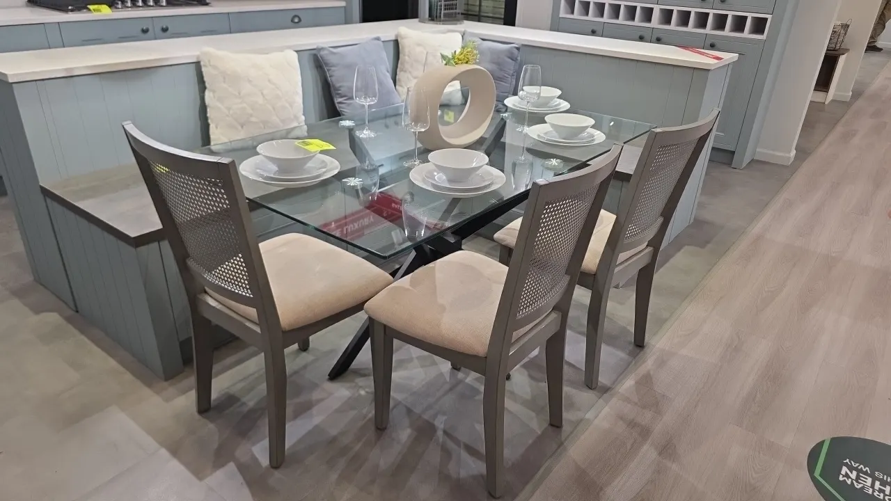Dining table set. Includes glass top table on a black metal geometric base and (3) wood dining chairs featuring cane backs and upholstered cushioned s