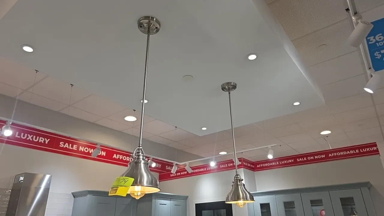 Metal pendant lights. Features brushed metal finish, downrod stem with round ceiling canopy, and bell-shaped metal shades with white interior. Dimensi