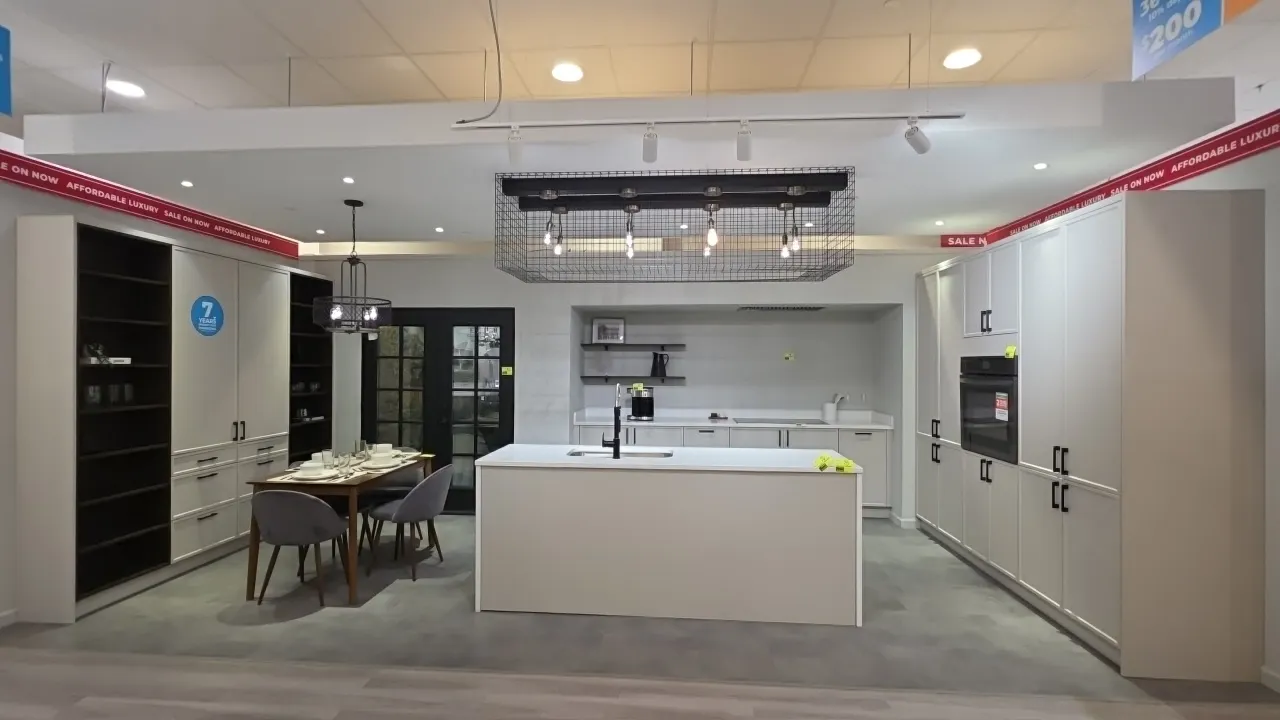 Infinity Plus kitchen cabinet suite. Includes 125" lower cabinets with solid surface countertops, (2) 45" wood wall shelves, 104" x 94"H oven wall cab