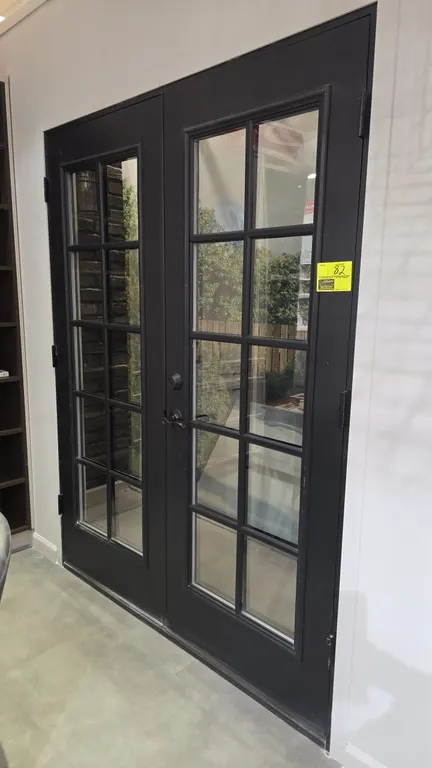 Set of French doors. Features a 10-lite glass pane design on each door with a dark gray finish. Includes Defiant lever handle and deadbolt hardware. 6