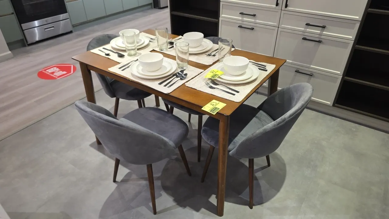 Dining table set. Includes wood table and (4) cushioned dining chairs. Chairs feature gray fabric upholstery with curved backs and tapered wood legs.