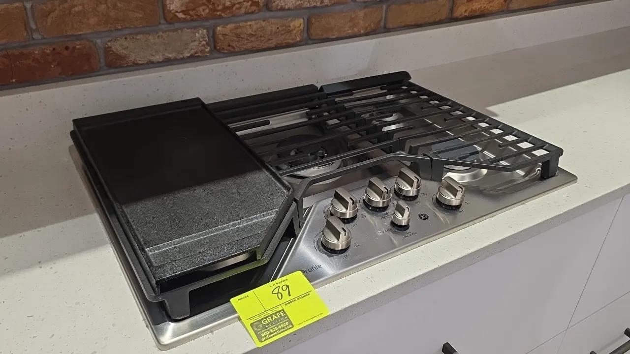General Electric Profile PGP9030SL2SS built-in 5-burner gas cooktop. Features stainless steel construction and continuous cast iron grates. Includes 9