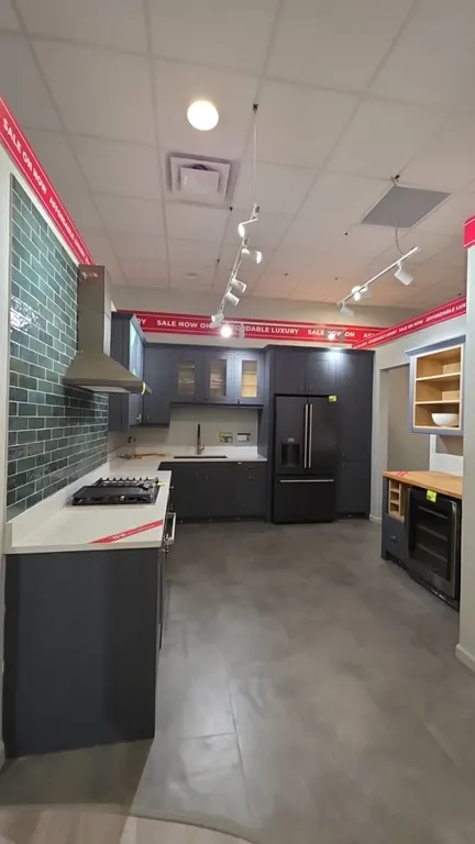 Infinity Plus kitchen cabinet suite. Includes 117" x 82" L-shape upper and lower cabinets with solid surface countertops, sink, faucet, and backsplash