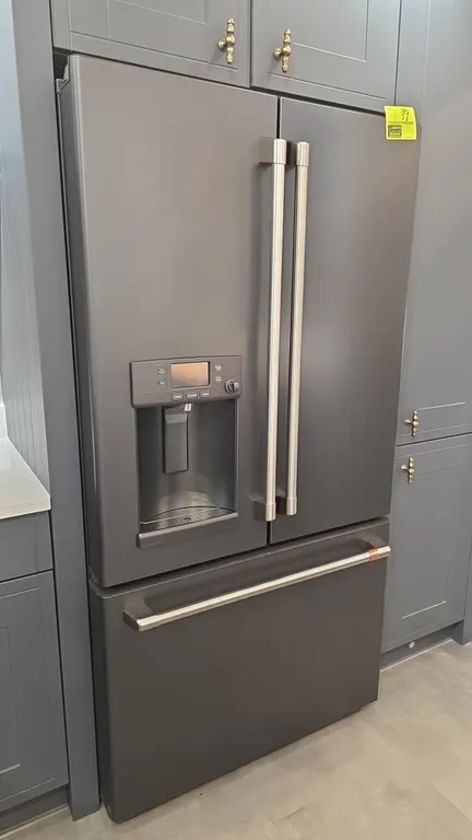 Café CYE22TP3MID1 French door refrigerator with bottom freezer drawer. Features built-in door water and ice dispenser with hot water option, TwinChill