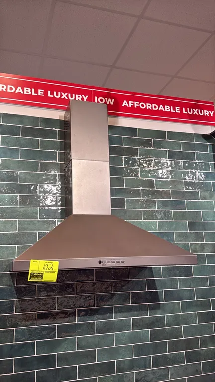 GE JVW5301EJ2ES 30" wall-mount pyramid chimney range hood. Features push-button controls with boost setting, integrated cooktop lighting, and telescop