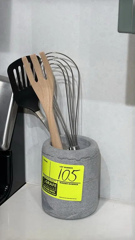 Assorted smallwares. Includes concrete-style utensil crock with assorted kitchen utensils (wire whisk, slotted turner, wooden fork) and (5) white cera