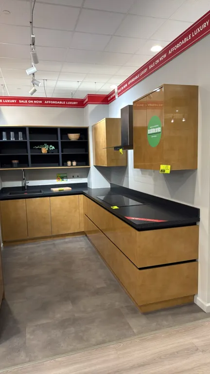 Wren Kitchens Infinity Plus L-shaped kitchen cabinet set. Includes upper and base cabinets, laminate countertops, sink, faucet, and oven wall cabinet