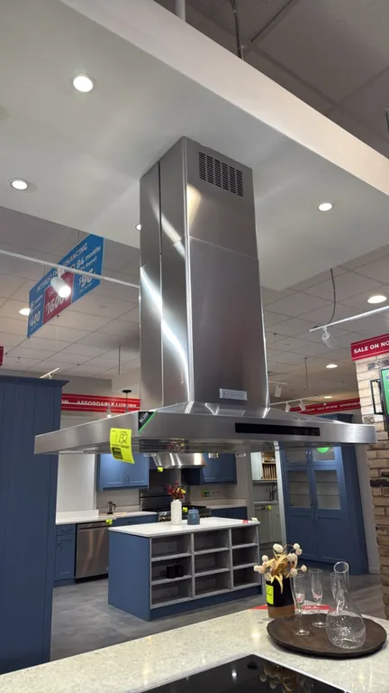 KitchenAid convertible island-mount range hood. Features stainless steel construction, integrated overhead lighting, electronic touch controls with mu