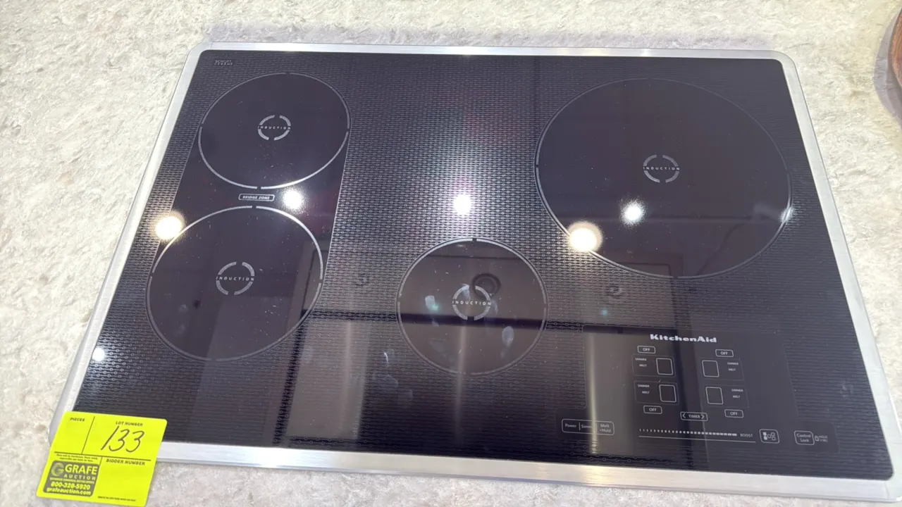 KitchenAid 31" built-in 4-element induction cooktop. Features Schott Ceran ceramic glass surface with stainless steel trim, digital touch controls, po