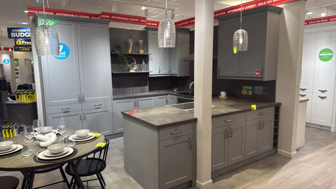 Infinity Plus U-shaped kitchen cabinet set. Features gray shaker-style doors and drawers, tall pantry cabinet, laminate stone-look countertops, single